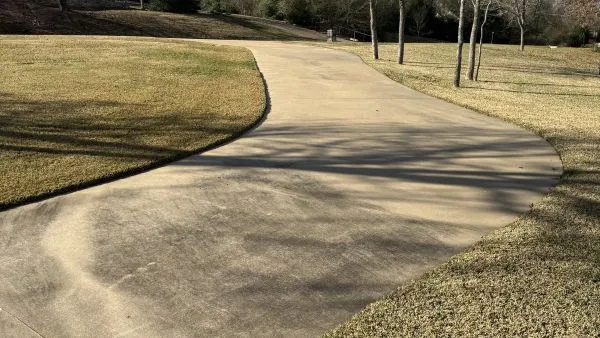 Residential driveway before pressure washing by Stonevale Exterior Co. showing staining and discoloration