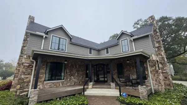 Petrified stone home exterior before cleaning by Stonevale Exterior Co. showing weathering and discoloration